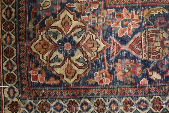 An Isfahan red ground medallion rug 202cm x 133cm